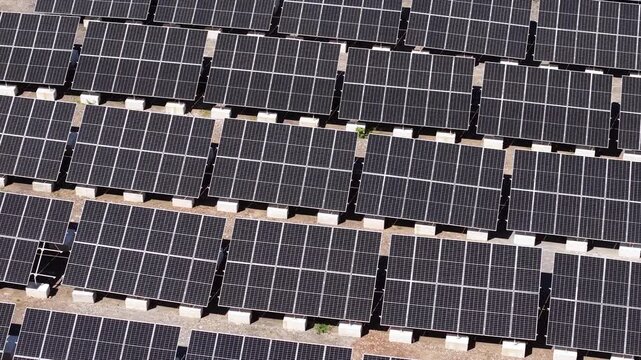 Drone Shot of Solar Power Plant, Flying Above Grid of Solar Panels on Sunny Day