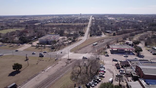 4K drone footage flying over railroad tracks in downtown Midlothian, Texas, capturing transportation infrastructure, urban development, and North Texas city scenery.