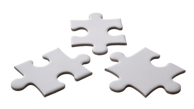 Three white puzzle pieces scattered