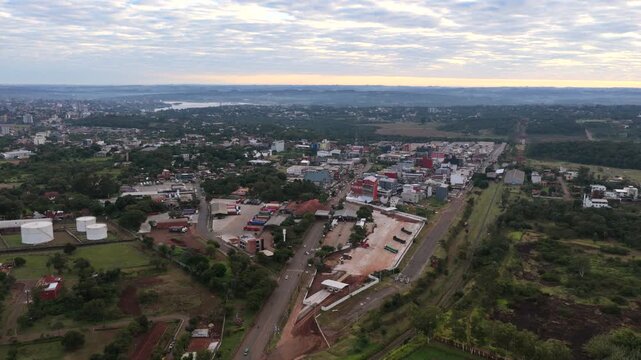 Drone flight above Encarnacions famous commercial district at sunrise with city streets illuminated by early morning light.
