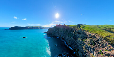 Aerial view of cliff coast and green pastures, Akaroa, New Zealand © zhang
