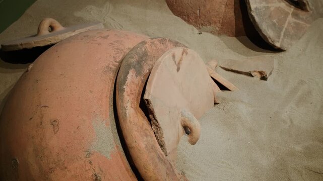 Weathered amphora rim on dusty surface