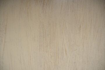 Obraz premium Scratched beige painted texture. Worn out pale yellow grunge surface background with distressed lines and empty copy space.