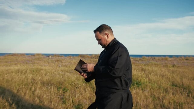 Monk Reading The Bible While Walking In The Nature 
