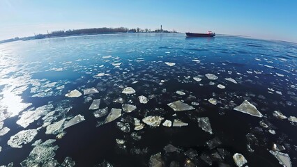Icebergs floating in cold arctic ocean with ship in background © Sorina