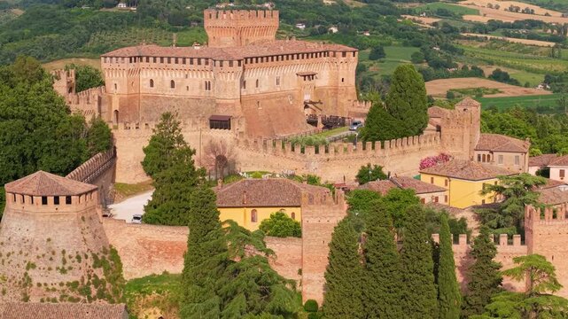 Gradara Marche Italy 4k drone 70mm telephoto of medieval borgo castle fortress. Beautiful villages of Italy tourist landmark tight compression zoom over castle walls towers rolling hills b-roll