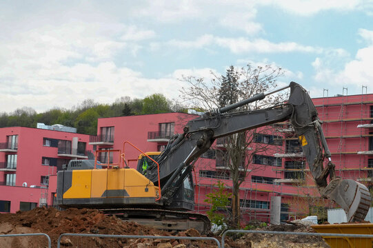 excavator at the construction site of a multi-storey building