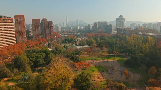 Aerial Flying high frame rate above Araucano Park with Las Condes Buildings and Costanera Center in Santiago de Chile