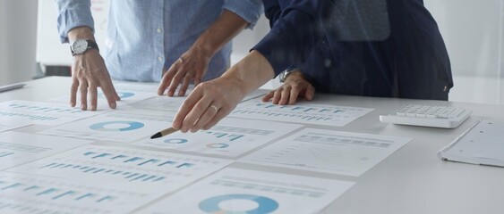Professional team analyzing financial reports, sharing insights and planning strategic decisions in modern workplace setting. Business people concept © rogerphoto