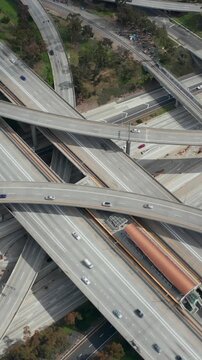 AERIAL: Slowly Circling over Judge Pregerson Huge Interchange showing multiple Roads, Bridges, Highway with little car traffic in Los Angeles, California on Beautiful Sunny Day 