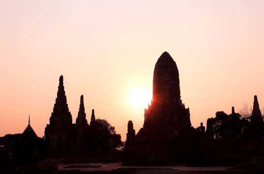 Sunset scene in Wat Chaiwatthanaram, Thailand. Picturesque scene with old temple, stupa and tree, Thailand, Southeast Asia. Topic of vacation, travel, trip, cruise, tour. Photo toned in yellow color