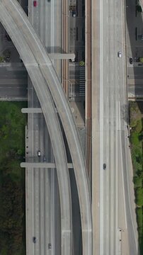AERIAL: Spectacular Overhead follow Shot of Judge Pregerson Interchange showing multiple Roads, Bridges, Highway with little car traffic in Los Angeles, California on Beautiful Sunny Day