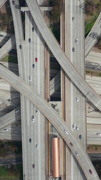 AERIAL: Spectacular Overhead follow Shot of Judge Pregerson Highway showing multiple Roads, Bridges, Highway with little car traffic in Los Angeles, California on Beautiful Sunny Day 
