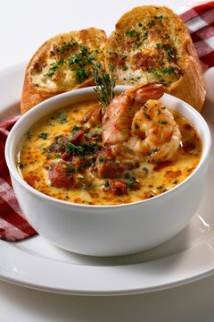 Creamy shrimp bisque served with toasted garlic bread and garnished with fresh herbs