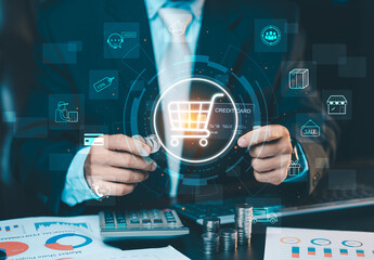 Fototapeta premium Businessman using credit card and virtual shopping cart icon for online shopping, digital payment and e-commerce technology concept.