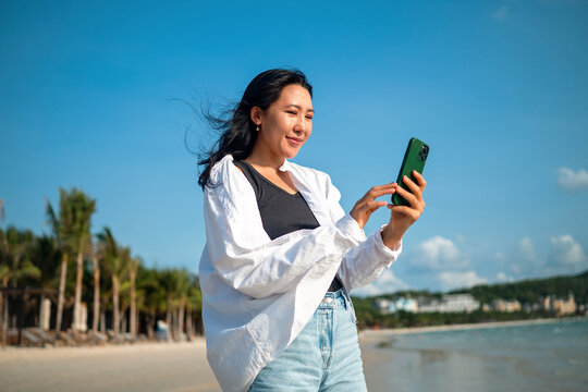 Mindful woman connecting with nature and feeling the breeze during a peaceful morning on the beach