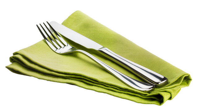 Silver fork and knife resting on folded green cloth napkin