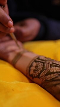 Vertical Close Up of Mehendi Applying on Bride's Hand