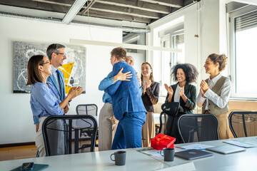 Naklejka premium Business colleagues celebrating success with applause, hugging, and surprise gift