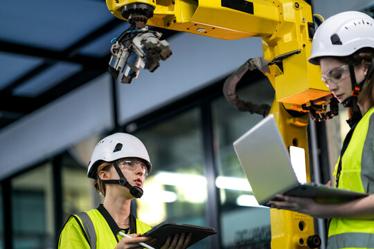 Visionary engineers inventing next-generation AI perception for robotic grippers. Technical team analyzing autonomous grasping logic in a high tech robotic innovation hub.