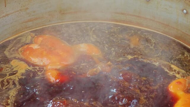 Boiled chicken in a pot broth.