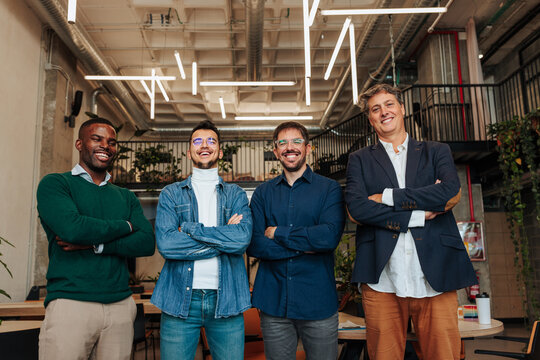 Diverse business team smiling at modern office workspace