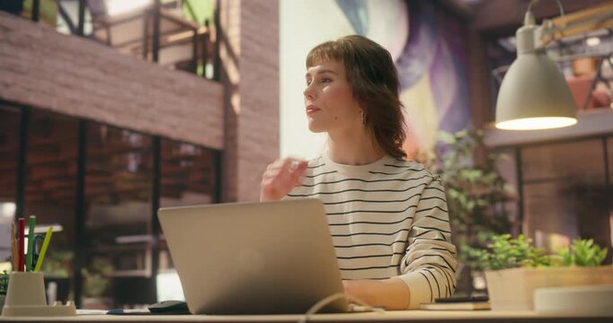 360 Degree. Thoughtful Caucasian Woman Types on Laptop in Stylish Loft Office, Building Ecommerce Brand, Financial Data and Driving Successful Digital Marketing Innovation. Cinematic Tracking