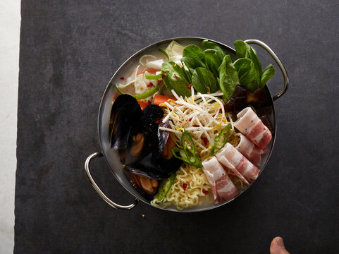 Spicy Korean Jjamppong Ramen with Mussels Pork Belly and Vegetables in Metal Pot