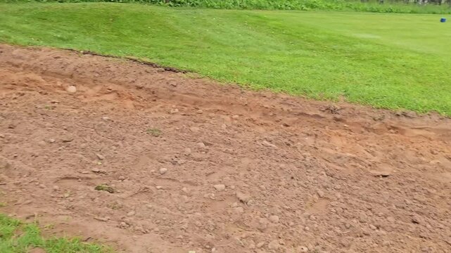 Golf course area gets leveled and prepared for new grass in summer