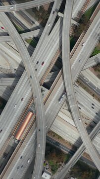 AERIAL: Spectacular Turning Overhead Shot of Judge Pregerson Highway showing multiple Roads, Bridges, Viaducts with little car traffic in Los Angeles, California on Beautiful Sunny Day 