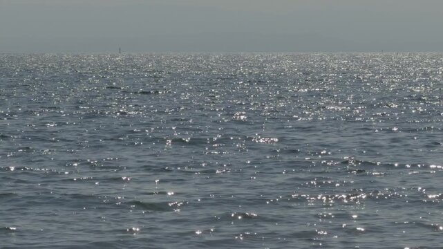 Calm Sea Water Surface With Bright Sun Glare Sparkles. Deep Sea Waves In Summer Sunshine Light. Marine 