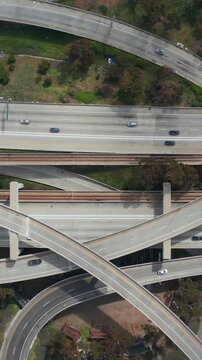 AERIAL: Spectacular Overhead follow Shot of Judge Pregerson Interchange showing multiple Roads, Bridges, Highway with little car traffic in Los Angeles, California on Beautiful Sunny Day