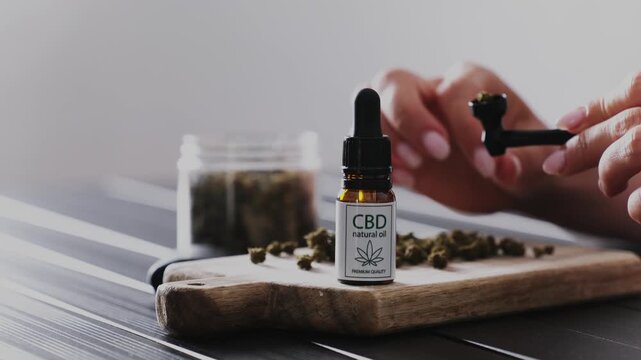 Girl Fills A Smoking Pipe With Dry CBD Cannabis For Reassurance