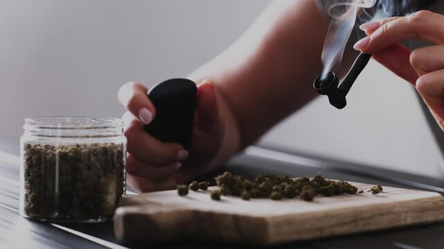 Girl Lights A Smoking Pipe With Dry CBD Cannabis And Smokes It With Thick Smoke For Calmness Of The Nervous System