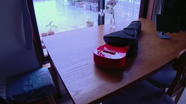Ukulele ready for practice with a gentle breeze, quiet signs of daily life in a calm home setting for music, hobby and lifestyle use
