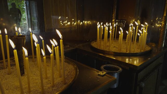 Burning Wax Candles In Church Candlesticks With Sand. Religious Ritual. Christian Orthodox Temple 