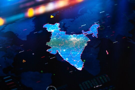 Digital map of India glows with data streams. Network lines pulse across its borders and states. Futuristic dashboard background suggests analytics. Ideal for tech, business. No people, no animals