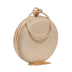 Generic unbranded Gold shimmer round evening clutch bag with rhinestone circle handle and gold chain isolated on white background. Elegant women luxury fashion accessory for gala commercial use. © Sceliano