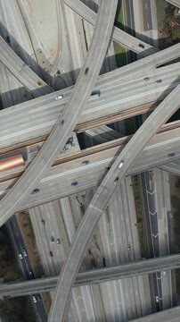AERIAL: Spectacular Turning Overhead Shot of Judge Pregerson Highway showing multiple Roads, Bridges, Viaducts with little car traffic in Los Angeles, California on Beautiful Sunny Day 