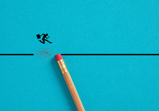 Businessman jumping gap erased by pencil rubber. Concept of overcoming challenges and defeating risks in business.