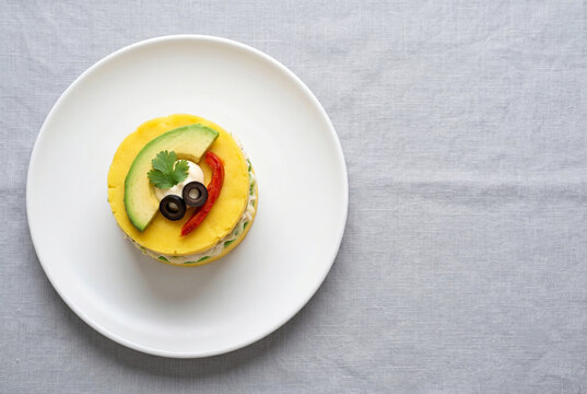 Causa Lime&ntilde;a - Layered Peruvian Yellow Potato Terrine with Avocado and Black Olive - with Copy Space