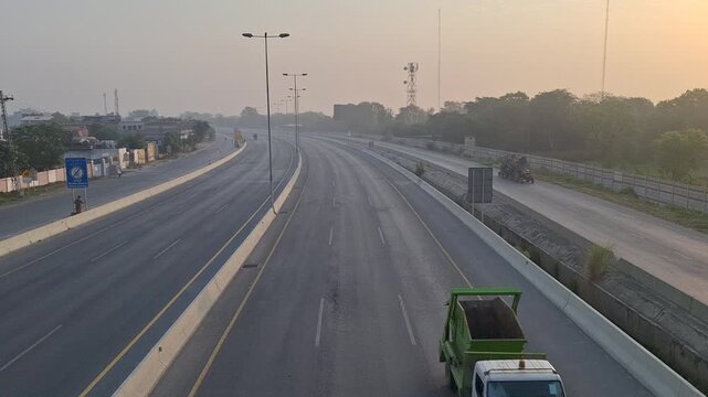 Timelapse of city traffic on Lahore Ring Road highway at sunset, Pakistan