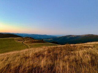 Fototapeta premium Sunset over the high pastures and rolling hills of the Schnepfenried