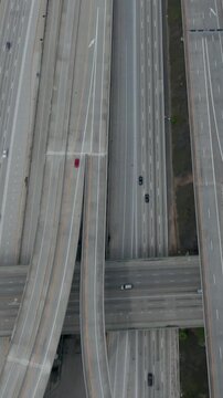 AERIAL: Slow Overhead Lookup over 110 Highway with little car traffic in Los Angeles, California on Cloudy Overcast Day 