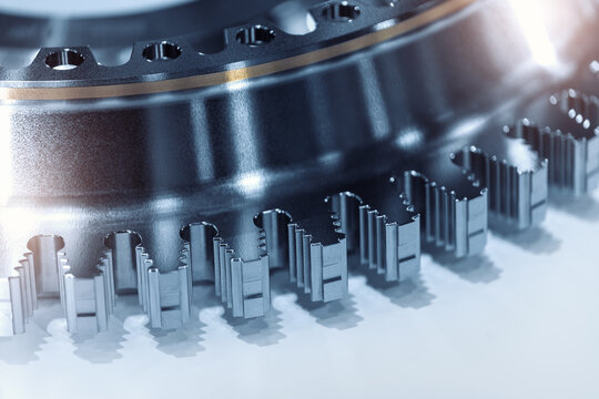 Close-up detail view precision machined metal gear wheel mechanism geometry polished steel industrial surface. Advanced engineering component manufacture quality durability technology accuracy