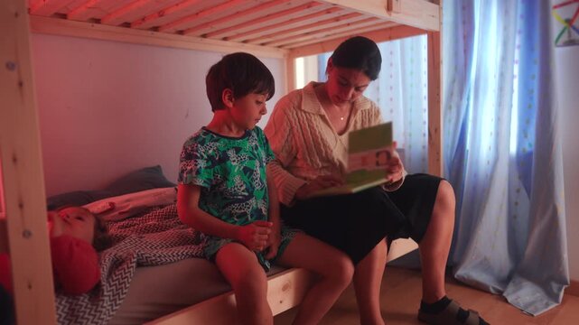 Mother and son sharing one on one reading session on bunk bed creating supportive learning environment focused on literacy development curiosity and parental involvement