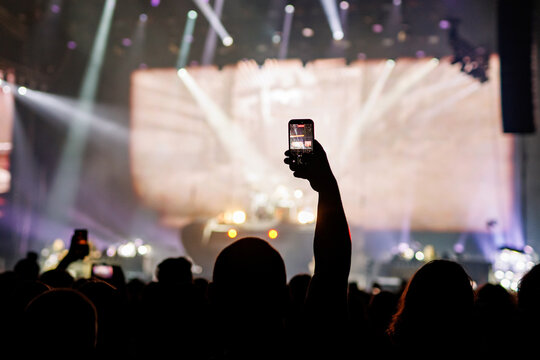 Person Recording Stage Performance with Mobile Phone at Concert