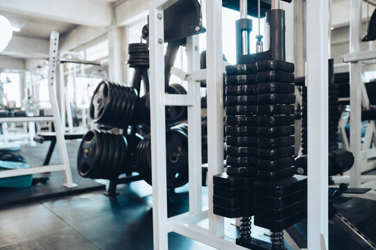 fitness concept. Gym weight machine with black weight stack in bright fitness room