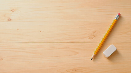 Obraz premium Pencil and Eraser on Wooden Desk with Copy Space, Education Background