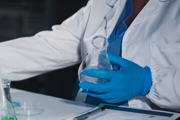 Fototapeta premium Female and Male Scientists Working on their Computers In Big Modern Laboratory. Various Shelves with Beakers, Chemicals and Different Technical Equipment is Visible.